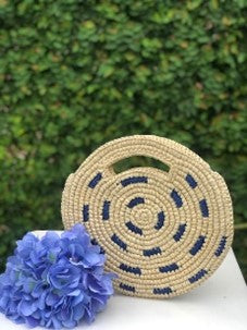 Round flat medium purse with blue accents made with toquilla straw