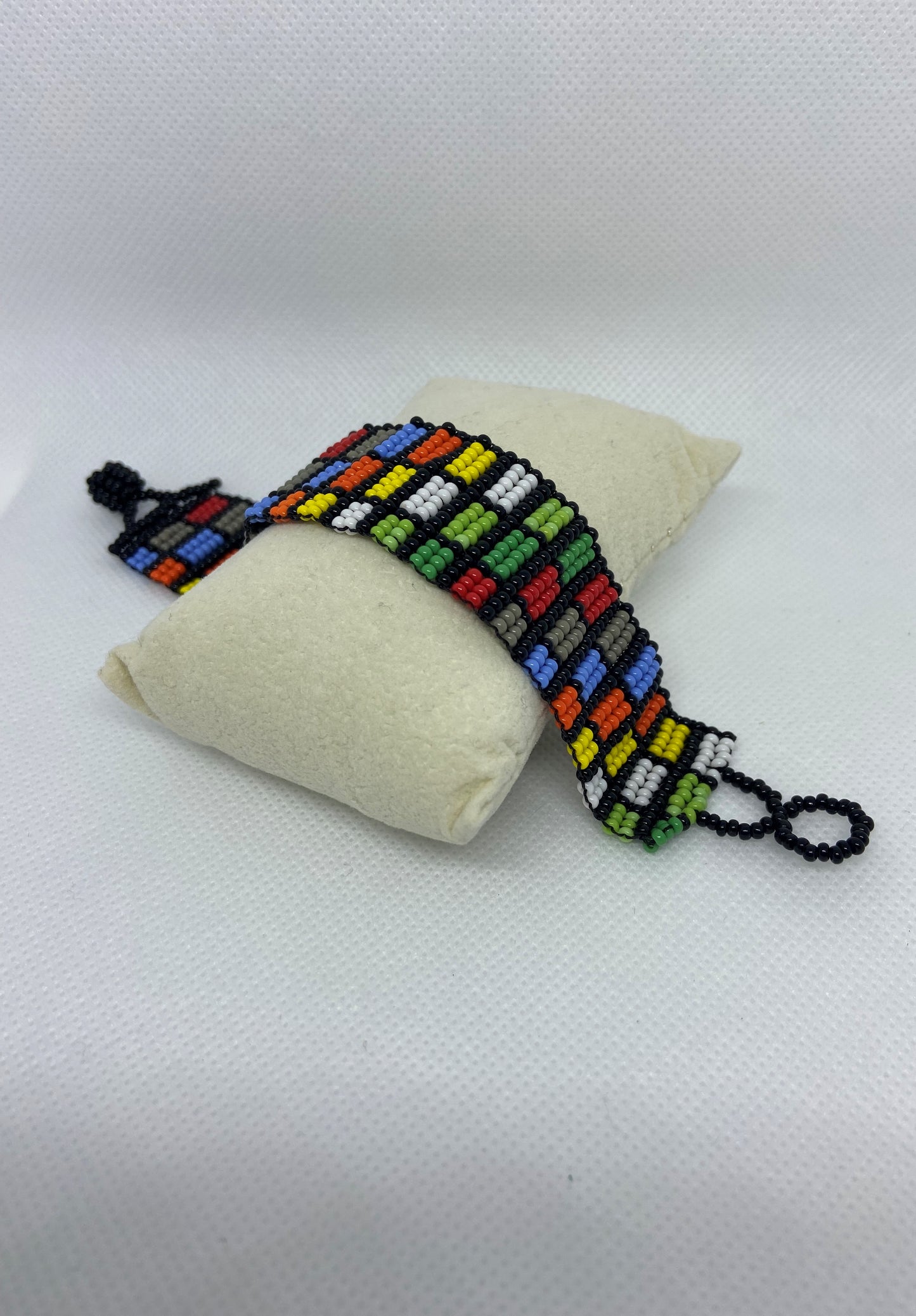 Chaquira bracelet made in form of little squares and colors